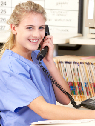 A woman wearing a blue shirt stands confidently, showcasing her style and poise in a vibrant setting.